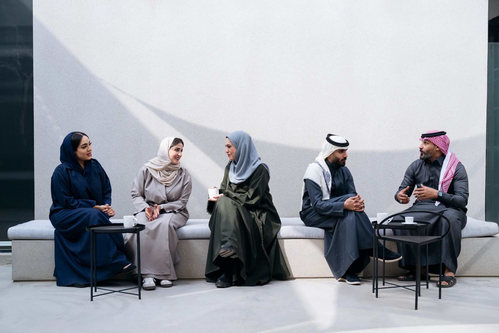 Business professionals in discussion outside a modern office